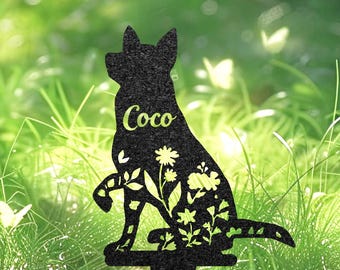 May include: Black metal dog silhouette garden stake with floral cutouts. The dog's name, "Coco", is written in a light green font. The stake is designed for gardens, adding a decorative touch to outdoor spaces.