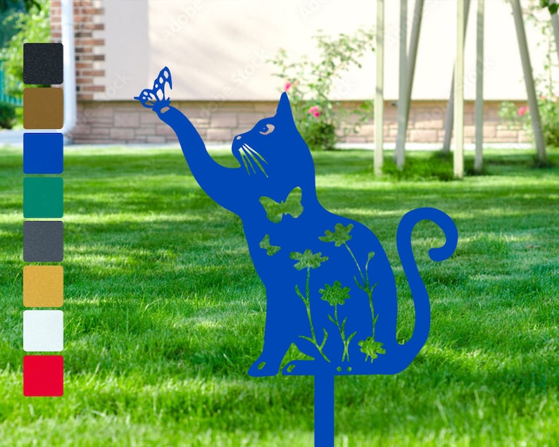 May include: A blue metal cat silhouette garden stake with a butterfly design. The cat is reaching up with its paw towards the butterfly. The stake is decorated with flowers and leaves.