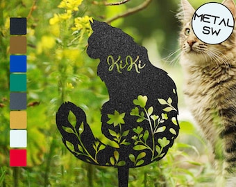 May include: Black metal silhouette of a cat with floral details and the name "Kiki" inscribed. The silhouette is standing on a metal stake.