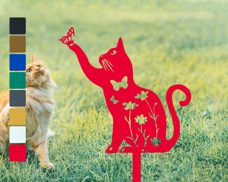 May include: Red metal cat silhouette garden stake with a butterfly and flowers cutouts. The cat is reaching up with its paw as if to catch the butterfly.