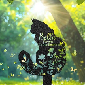 May include: Black metal silhouette of a cat with flowers and the text "Bella Forever In Our Hearts".