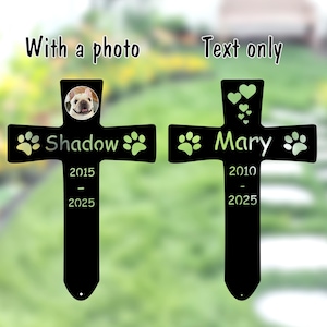 May include: Two black metal pet memorial crosses. One cross features a photo of a dog, the name "Shadow", paw prints, and the years 2015-2025. The other cross has the name "Mary", paw prints, hearts, and the years 2010-2025. The words "With a photo" and "Text only" are above the crosses.
