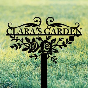 May include: Black metal garden sign with the text "CLARA'S GARDEN" and decorative floral accents.