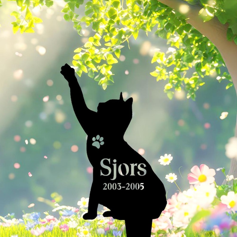 May include: A black cat silhouette garden stake featuring a paw print cutout, the name Sjors, and the years 2003-2005. The cat is depicted in a seated position with one front paw raised upward as if reaching toward the branches of a tree.