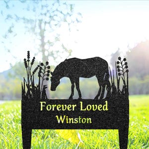 May include: Black metal garden stake with a silhouette of a horse and the words "Forever Loved Winston".