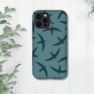 May include: A teal blue phone case with a repeating pattern of dark blue stylised bird silhouettes.