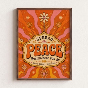 May include: A framed wall art print featuring a wavy orange and pink background with stylized flowers and the text SPREAD PEACE Everywhere you go more peace - less hate in a central decorative emblem with bold orange lettering.