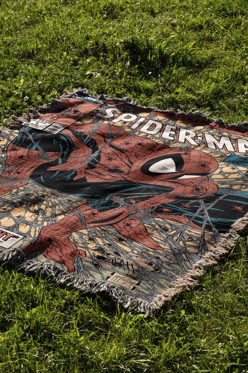 A Jacquard-woven blanket featuring a textured, intricate artwork woven into the fabric. The design showcases a stella comic design. The blanket appears thick and soft, suggesting it is both a decorative piece and a cozy item for warmth.