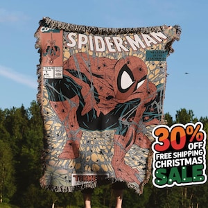 A Jacquard-woven blanket featuring a textured, intricate artwork woven into the fabric. The design showcases a stella comic design. The blanket appears thick and soft, suggesting it is both a decorative piece and a cozy item for warmth.