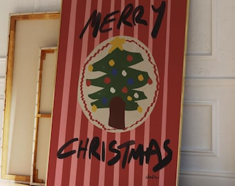 May include: A framed Christmas art print with a red and white striped background. The print features a green Christmas tree with colorful ornaments inside a circle, and the words "MERRY CHRISTMAS" in black.