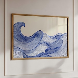May include: A rectangular wall art piece featuring a blue line-art illustration of ocean waves against a cream-colored background, enclosed in a thin, light-toned wooden frame. The design consists of continuous, flowing blue lines.