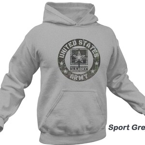May include: A gray hooded sweatshirt with a distressed, camouflage-style graphic of a US Army logo. The logo features a star and the words "United States Army".
