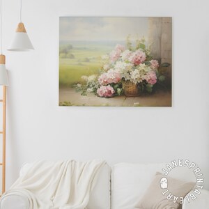 May include: A painting of a basket of pink and white hydrangeas, with a view of a green field in the background.