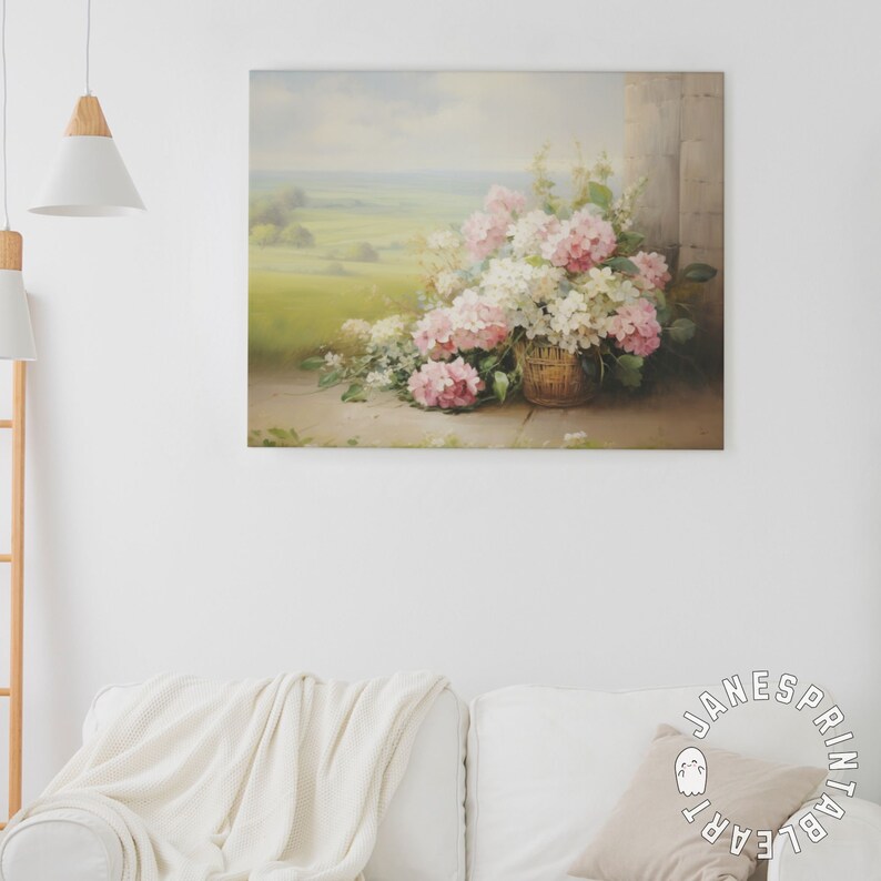 May include: A painting of a basket of pink and white hydrangeas, with a view of a green field in the background.