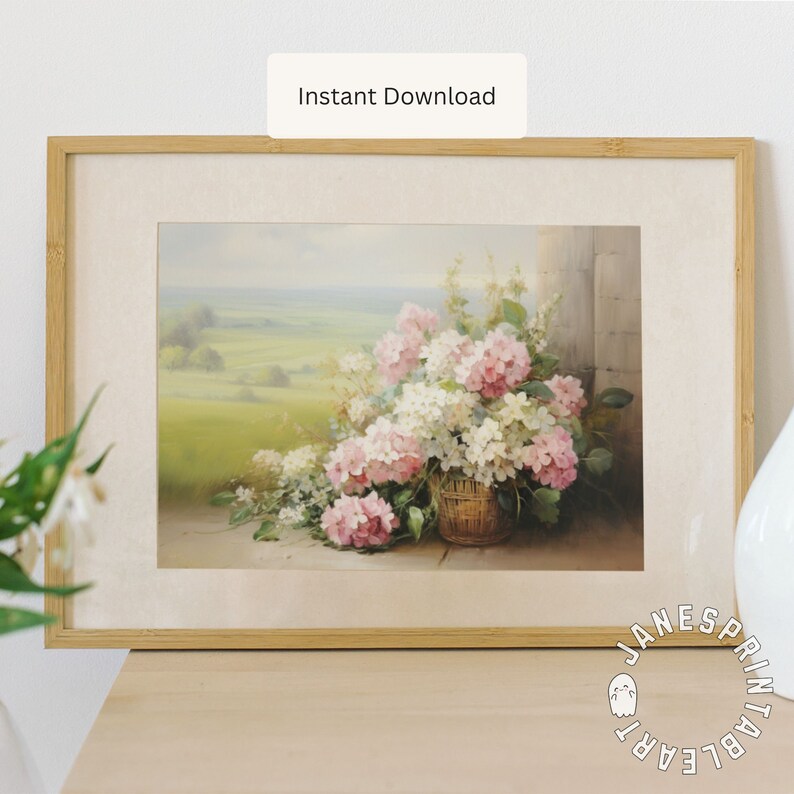 May include: A framed print of a still life painting featuring a basket of pink and white flowers. The flowers are arranged in a wicker basket and are set against a backdrop of a green field and a blue sky.