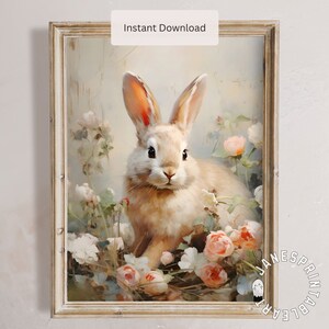 May include: A framed print featuring a light brown rabbit surrounded by pink and white roses. The artwork has a soft, painterly style with the text "Instant Download" at the top. The overall theme is a vintage floral and animal illustration.