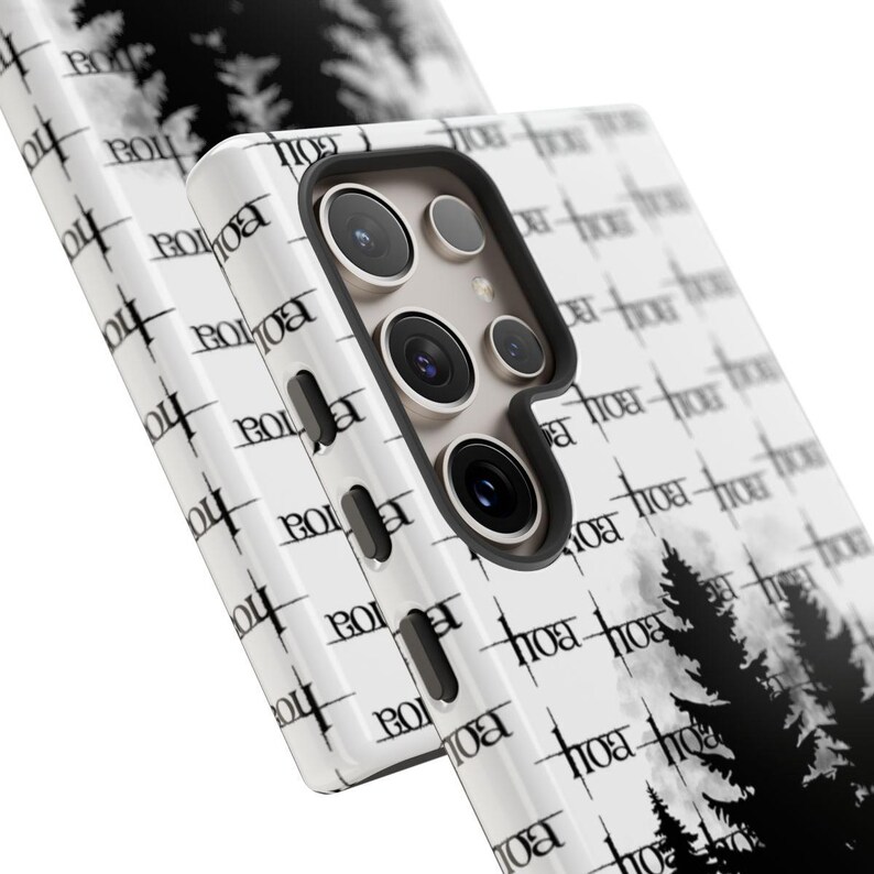 May include: White phone case with a black and white forest silhouette design. The case has the word "BOI" repeated across the surface. The phone case has a black border and a camera cutout.