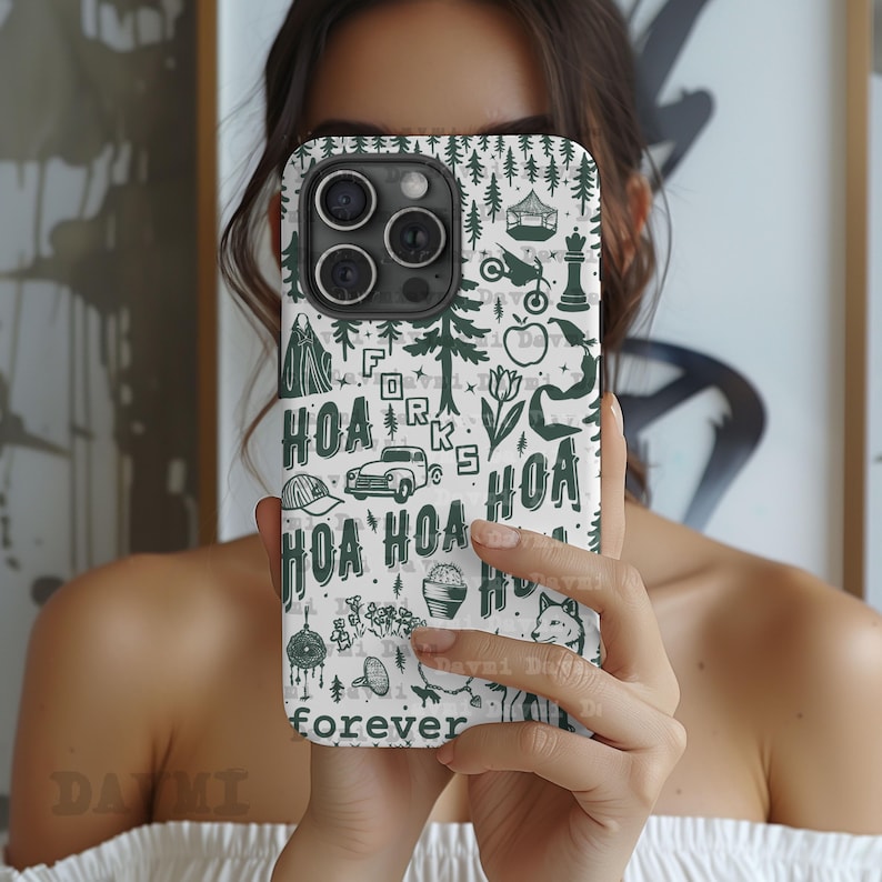 May include: A white phone case with a green pattern featuring trees, a car, and the text "HOA forever." The case has a dark green camera module and a variety of small illustrations. The overall design is whimsical and nature-themed.