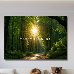 May include: A canvas print depicting a forest scene with a road leading towards a bright sunburst. The text "TRUST THE DUST" is displayed in white. The artwork evokes a sense of nature and tranquility.