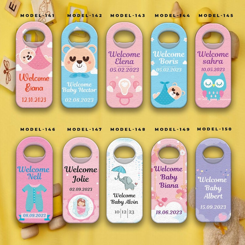 May include: A collection of ten bottle opener door hangers with baby-themed designs. Each features a unique color scheme, baby-related illustrations, and the text "Welcome" followed by a baby's name and date.
