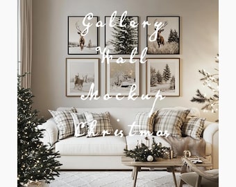 May include: A white couch with pillows and a throw blanket sits in front of a gallery wall with six framed prints. The prints feature images of deer, trees, and a snowy forest scene. A small Christmas tree with white lights sits in the corner of the room.