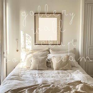 May include: A white bed with a beige linen duvet cover and pillows. A wooden frame with a blank canvas hangs on the wall above the bed. The room is decorated in a minimalist style.