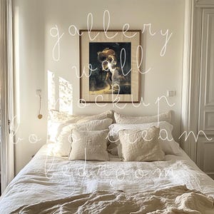 May include: A white linen bed with a brown throw blanket and a framed painting of a woman carrying a basket on a wall above the bed. The painting is in a wooden frame.
