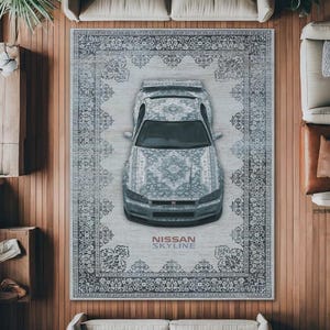 May include: An overhead shot of a gray Nissan Skyline car parked on a large rug with a traditional pattern. The rug is centered on a wooden floor, surrounded by furniture. The car and rug share a similar design. The text "NISSAN SKYLINE" is visible.