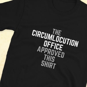 Pode incluir: Camiseta preta com texto branco que diz "The Circumlocution Office Approved This Shirt".