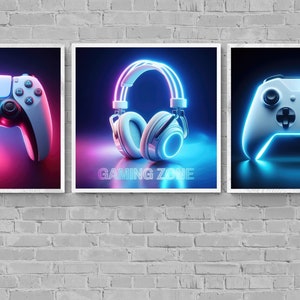 Könnte beinhalten: Drei gerahmte Drucke mit einem Gaming-Thema. Der linke Druck zeigt einen weißen und schwarzen Videospiel-Controller mit pinken und blauen Neonlichtern. Der mittlere Druck zeigt ein weißes Gaming-Headset mit blauen und pinken Neonlichtern und dem Text "GAMING ZONE". Der rechte Druck zeigt einen weißen und schwarzen Videospiel-Controller mit blauen Neonlichtern.