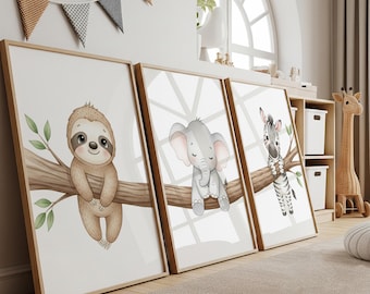 May include: Three framed art prints with cartoon animals: a sloth, an elephant, and a zebra. Each animal sits on a branch with green leaves. The prints have light wood frames and are displayed in a nursery. The prints are in a nursery setting.
