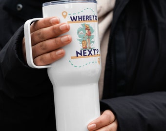 May include: White travel mug with a handle, featuring the text "WHERE TO NEXT?" and a graphic of a traveler with luggage. The design includes a map with dotted lines and location markers. The mug is held by a person.