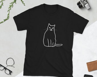 May include: Black t-shirt featuring a white outline of a cat sitting with a serious expression.