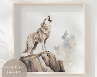 May include: Cross-stitch pattern PDF of a howling wolf on a rocky outcrop. The wolf is rendered in shades of brown and gray, with a light gray background and a light wooden frame. The text "Cross Stitch Pattern PDF" is in a circle at the bottom.