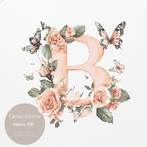 May include: A cross-stitch pattern featuring the letter "B" in a soft peach color, surrounded by peach roses, green leaves, and butterflies. The design includes the text "CROSS STITCH Pattern PDF".
