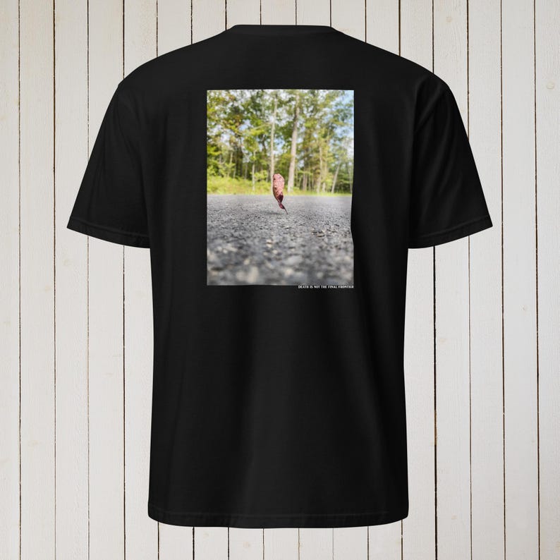 Peut inclure: T-shirt noir avec un graphique d'une feuille sur une route. Le texte "Death is not the final chapter" est imprim&eacute; sous l'image.