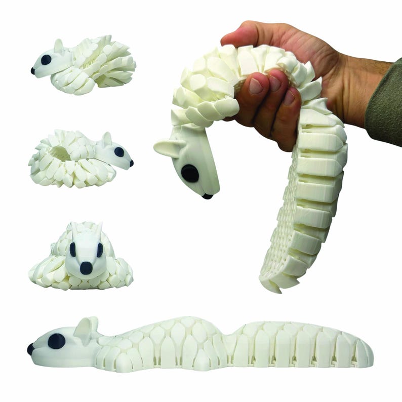 May include: A white, articulated squirrel toy with black eyes and a segmented body. The toy is shown in various poses, including curled up, stretched out, and held in a hand. The design features a detailed, textured surface.
