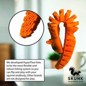 May include: Orange toy squirrel with a flexible, linked design. The toy has a detailed squirrel head and a tail made of connected segments. A close-up shows the textured links. The text says "HyperFlexi links" and "SKUNK PRINTS."