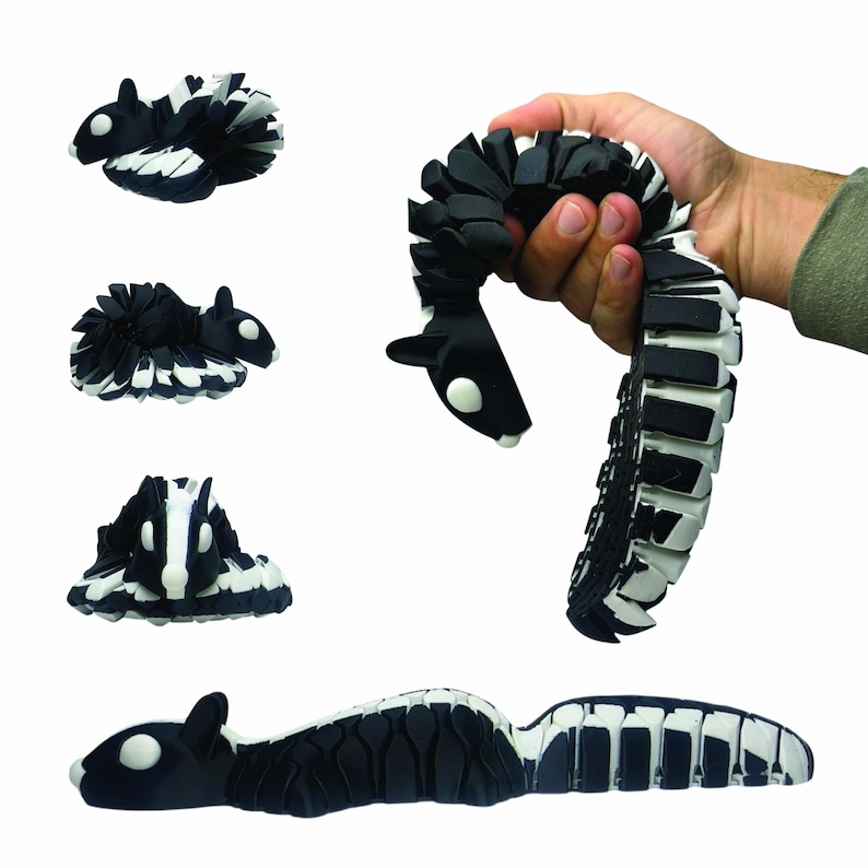 May include: Black and white articulated toy skunk in various poses. The toy is made of flexible, segmented pieces, allowing it to be posed in different positions. The skunk has a white stripe down its back and white accents on its face.