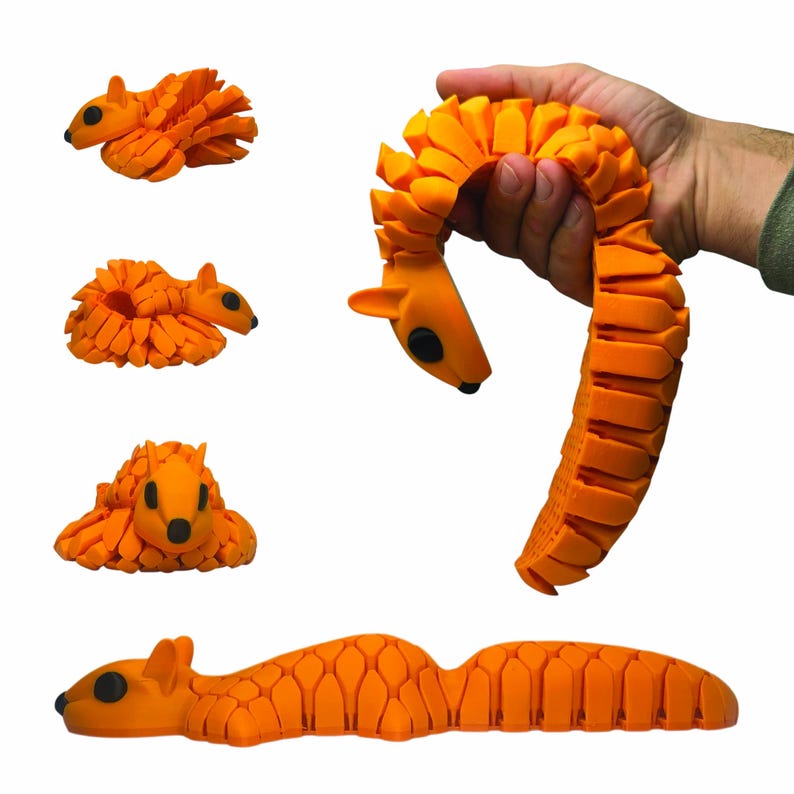 May include: Orange articulated squirrel toy with black eyes and a segmented body. The toy is shown in multiple poses, including curled up and extended. The toy is held in a hand in one image. The toy is made of a flexible material.