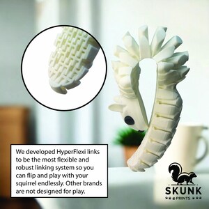 May include: A white, articulated squirrel toy with a black eye and a flexible, segmented body. The toy is designed with HyperFlexi links for play. The image includes text that says "SKUNK PRINTS".