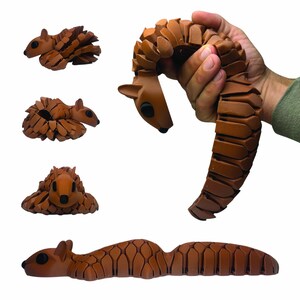 May include: Brown articulated squirrel toy in various poses. The toy is made of interlocking segments, allowing it to be posed in different positions. The squirrel has black eyes and a detailed, textured surface. The image shows the toy in several configurations.