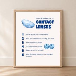 May include: A framed educational poster titled TIPS FOR PROPER USE OF CONTACT LENSES. It features a blue contact lens illustration, a numbered list of six safety instructions, and a blue contact lens case labeled with L and R.