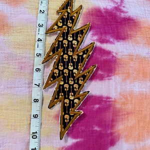 9 inch 13 point appliqué patch with guitars.