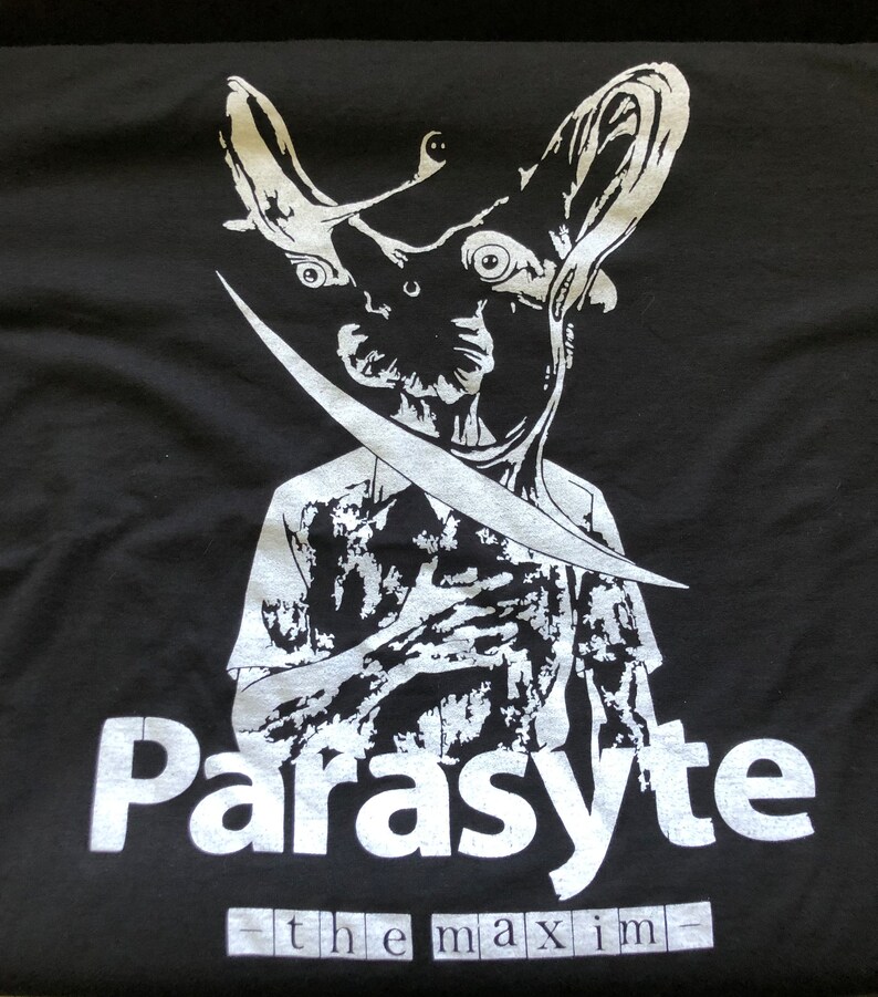 May include: Black t-shirt with a white graphic of a creature with large eyes and a blade. The word "Parasite" is printed in large white letters, with "the maxim" below.