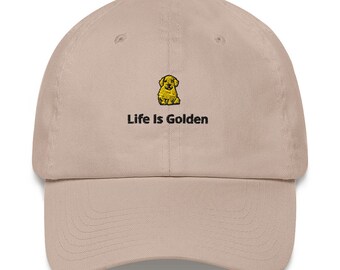 May include: A beige baseball cap with an embroidered yellow puppy and the text "Life Is Golden".