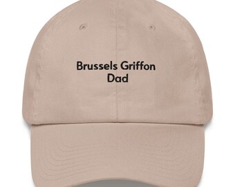 May include: A beige baseball cap with the text "Brussels Griffon Dad" embroidered in black.