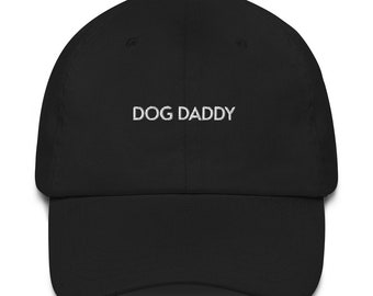 May include: A black baseball cap with white embroidered text that reads "DOG DADDY".