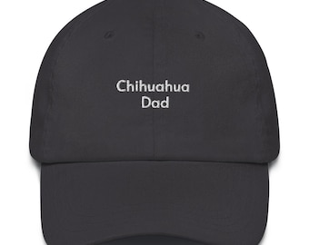 May include: A dark gray baseball cap with the embroidered text "Chihuahua Dad" in white. The cap has a curved brim and a fabric-covered button on top. A casual accessory for dog lovers.