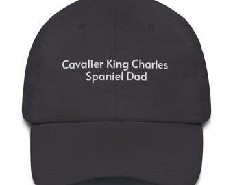 May include: A black baseball cap with white embroidery that reads "Cavalier King Charles Spaniel Dad".